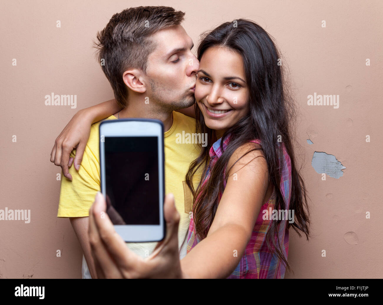 Young happy couple in love taking a selfie Stock Photo - Alamy