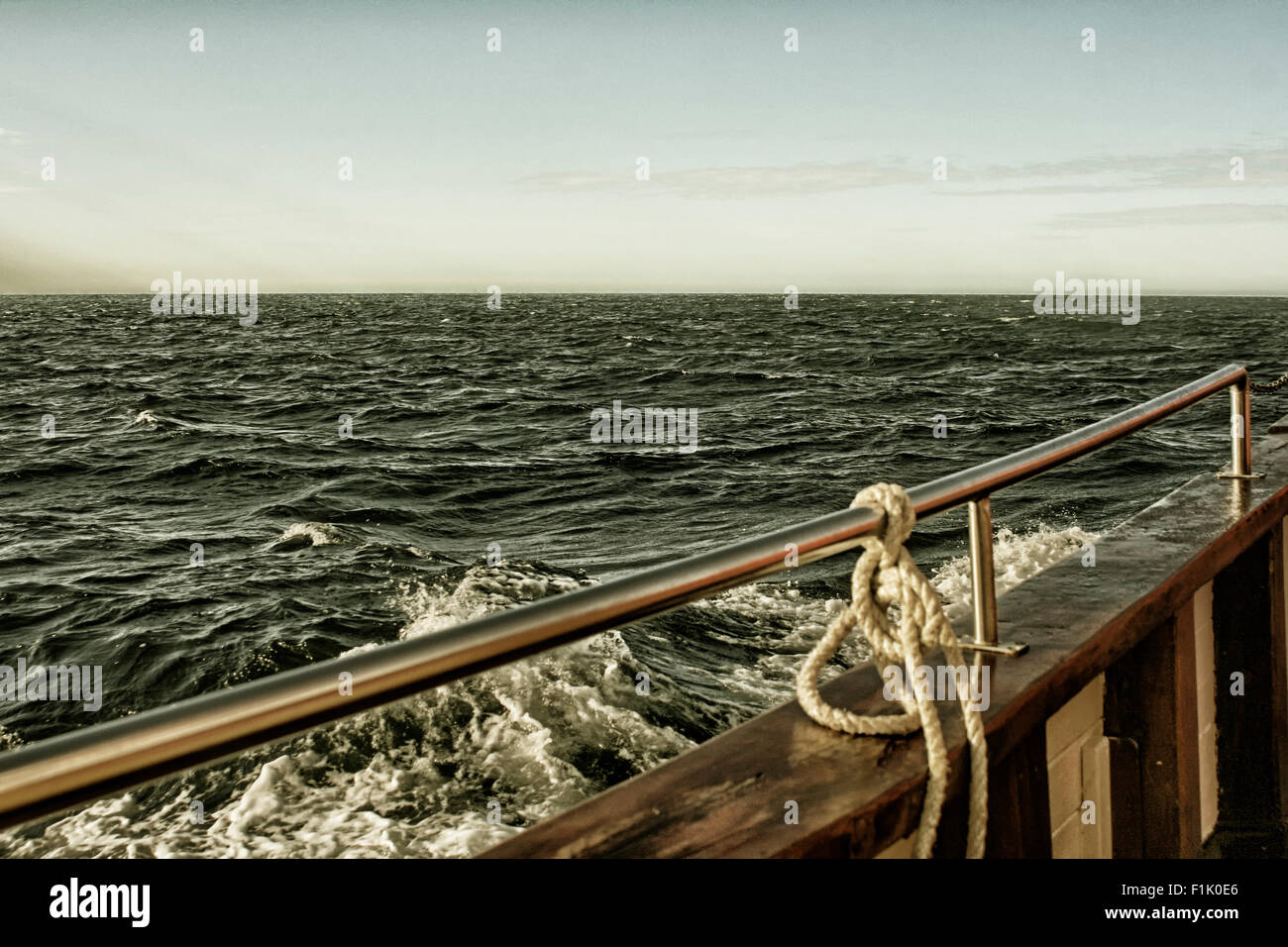 A wooden ship with a wet deck sailing on a bumpy sea Stock Photo - Alamy