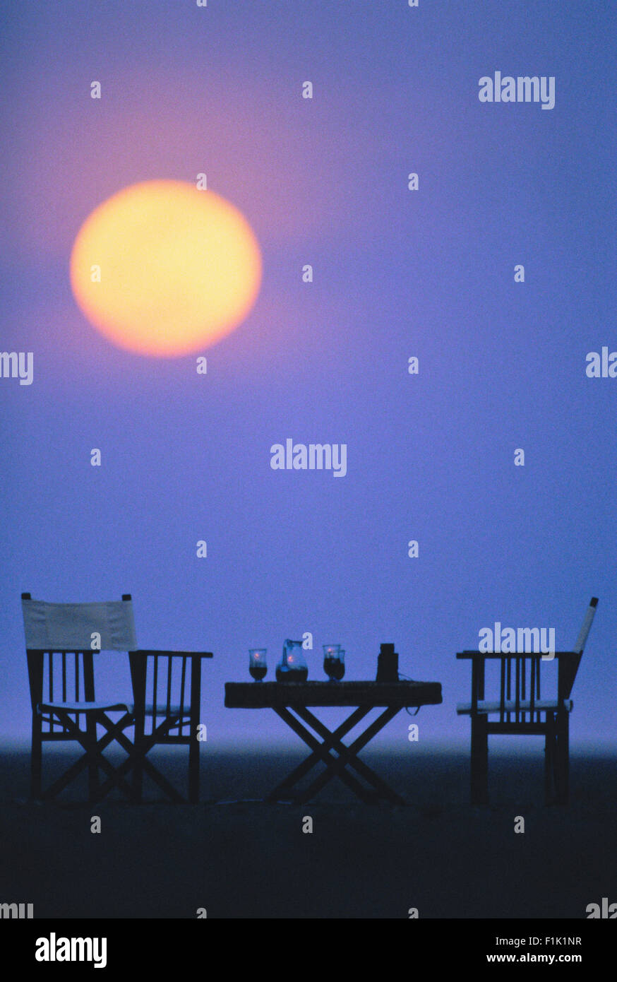 Table and Chairs with Drinks Outdoors at Dusk Stock Photo Alamy