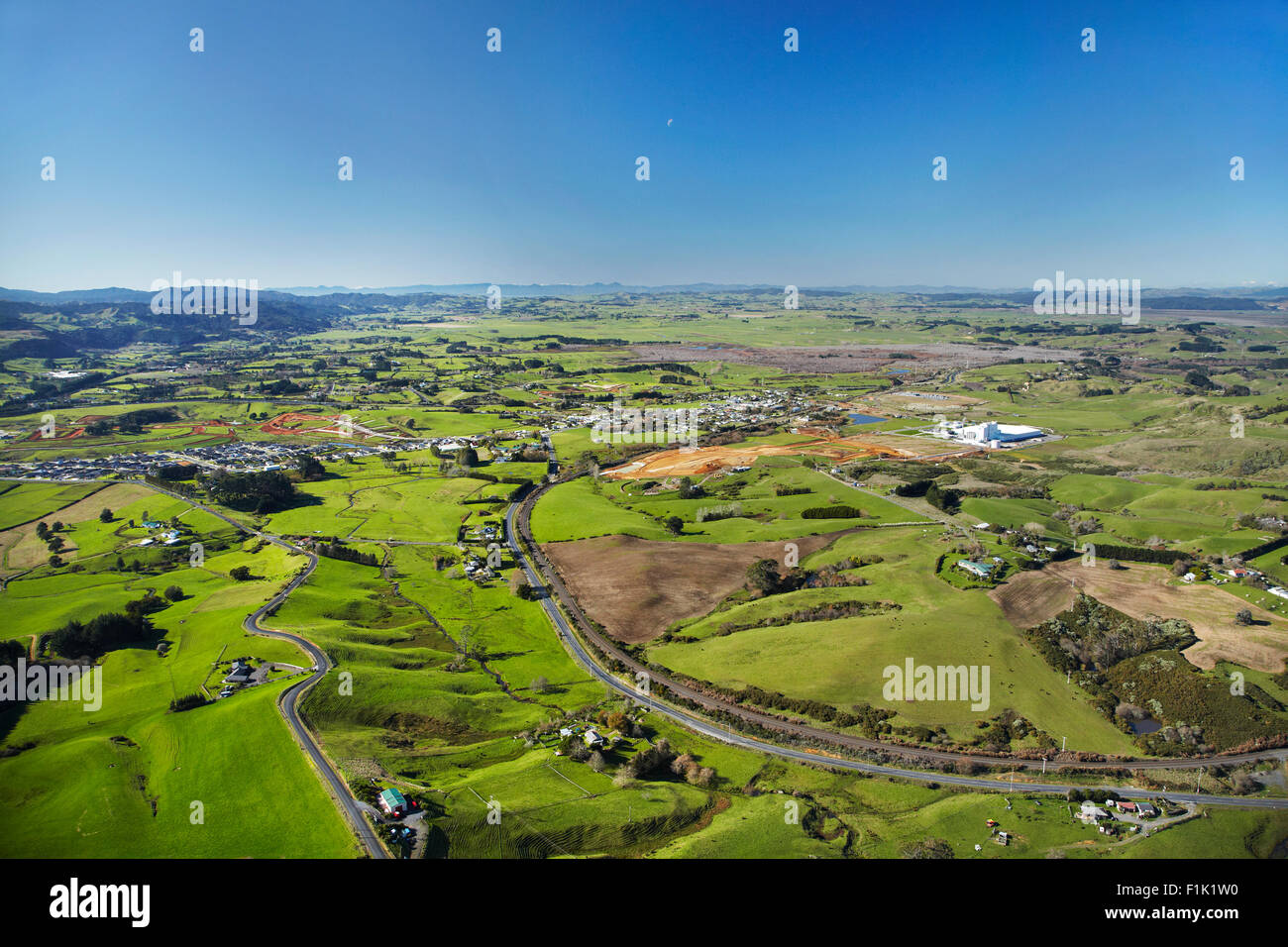 Farmland, road and railway, Pokeno, South Auckland, North Island, New Zealand - aerial Stock Photo