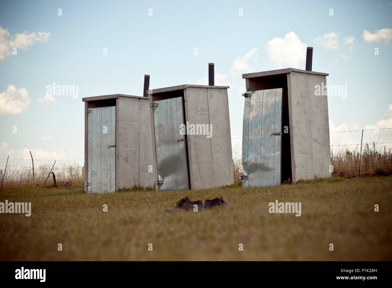 Landscape shot of three outhouse buildings Stock Photo