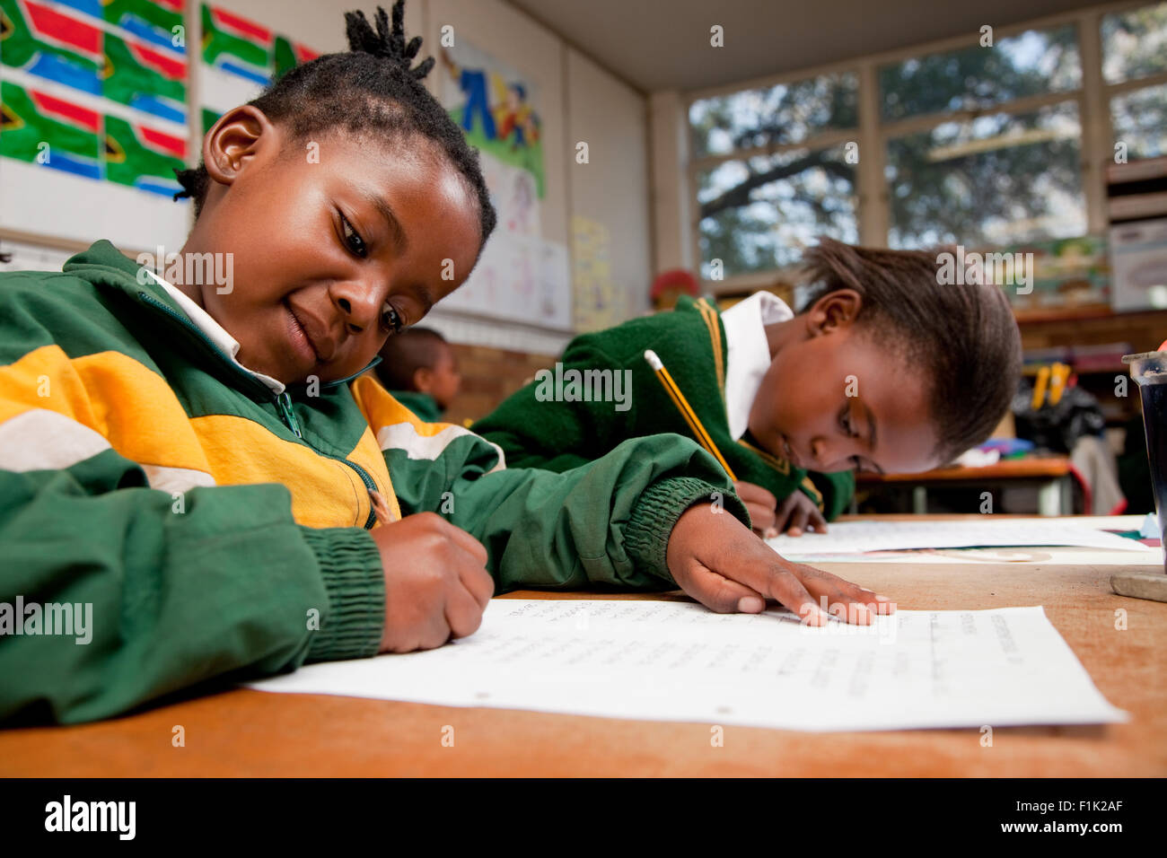 Two young girls writing at a desk, Meyerton Primary School, Meyerton, Gauteng Stock Photo