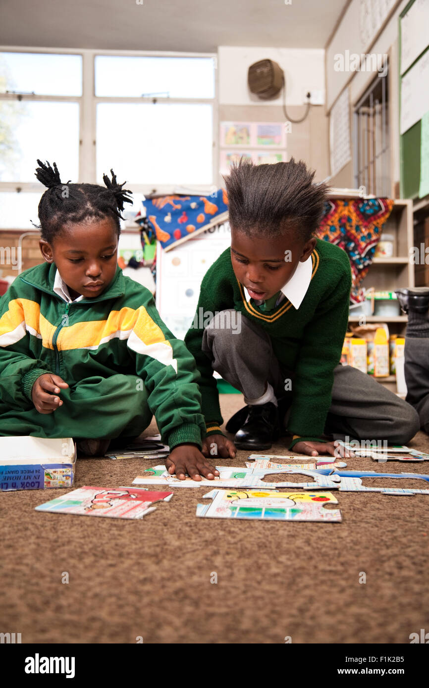 Two girls sitting on the floor building puzzles, Meyerton Primary School, Meyerton, Gauteng Stock Photo