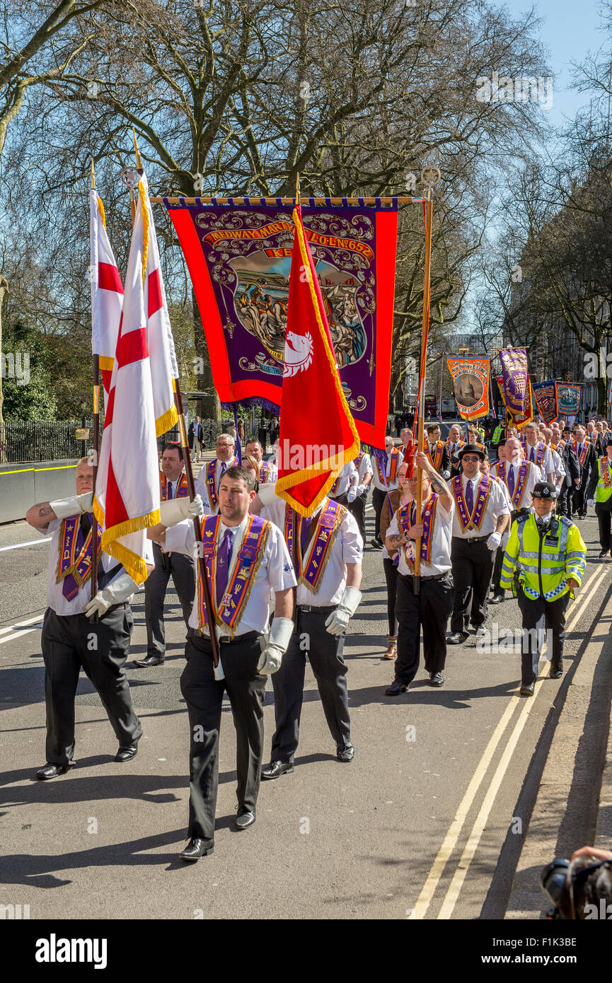St Georges Day Orange parade in City of London being escorted by the Metropolitan Police,England. Stock Photo