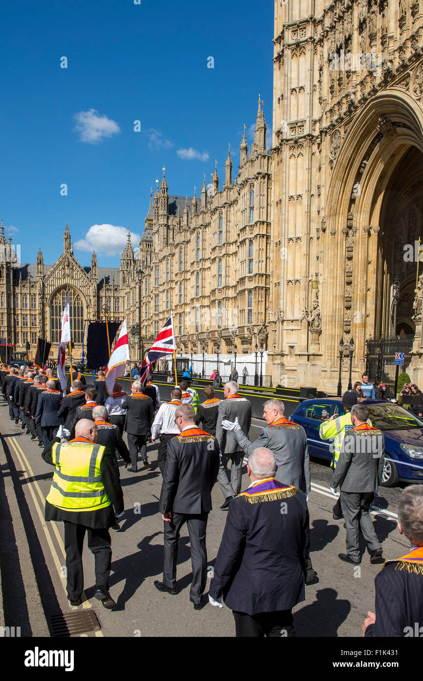 St Georges Day Orange parade outside the Houses of Parliament in the City of London being escorted by the Metropolitan Police. Stock Photo