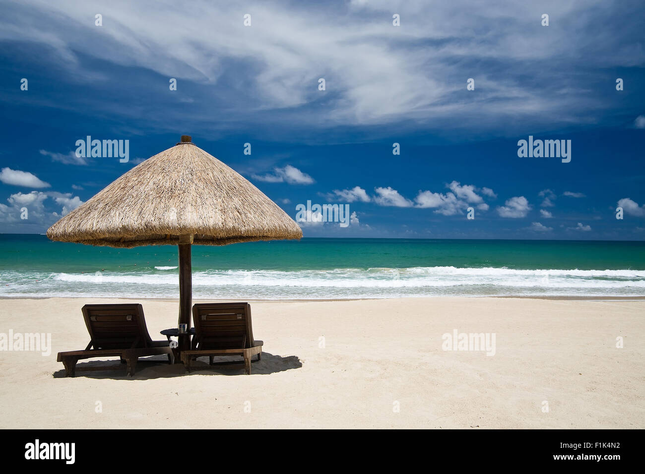 Beach with an umbrella and chairs Stock Photo