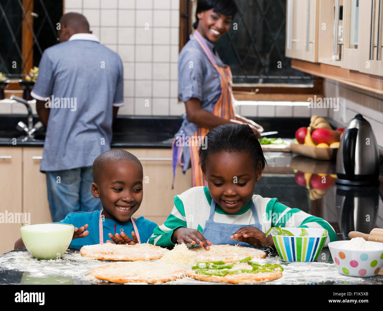 Two young African children preparing food together while their 