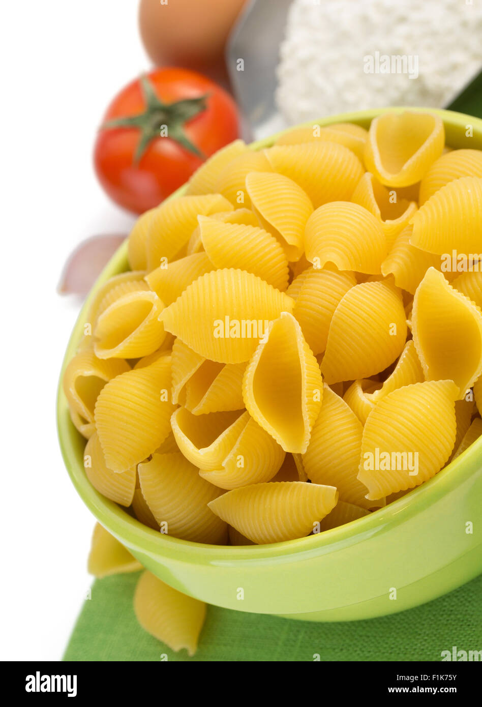 pasta shells in plate isolated on white background Stock Photo - Alamy