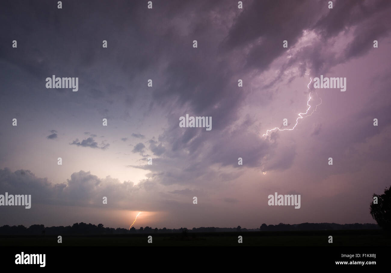 Thunder and lightning at the end of a hot and moistly summer day in the Netherlands Stock Photo