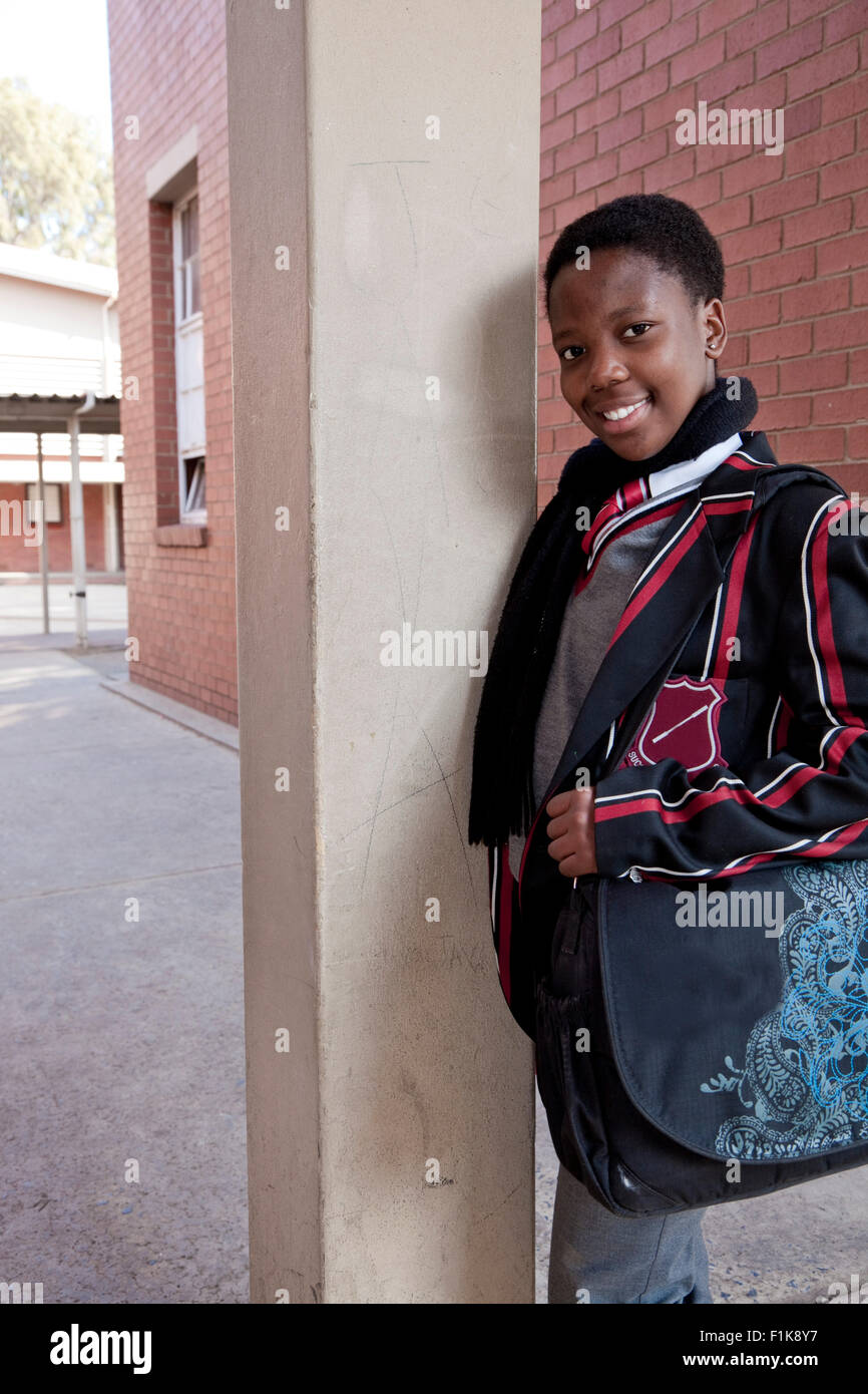 A Female high school student poses and smiles for the camera Stock Photo