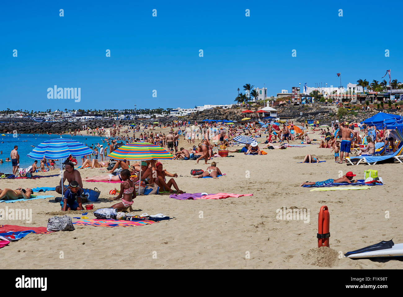 Holidaymakers Enjoying A Day On Dorado Beach In Playa Blanca