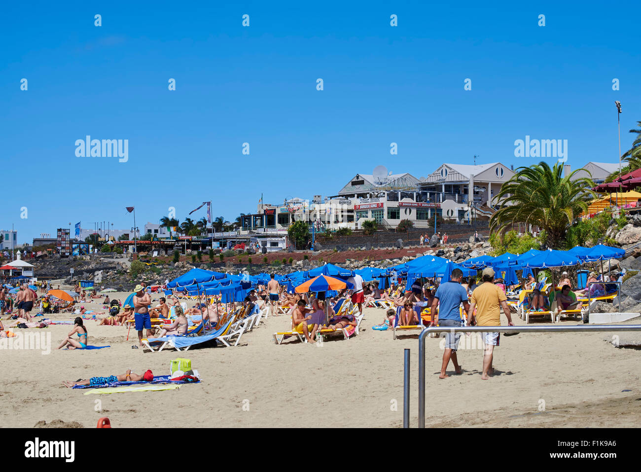 Holidaymakers Enjoying A Day On Dorado Beach In Playa Blanca
