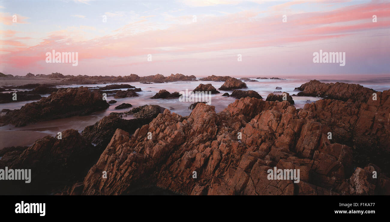 Rocky coastline at sunset. Knysna, Garden Route, Western Cape, South Africa, Africa Stock Photo