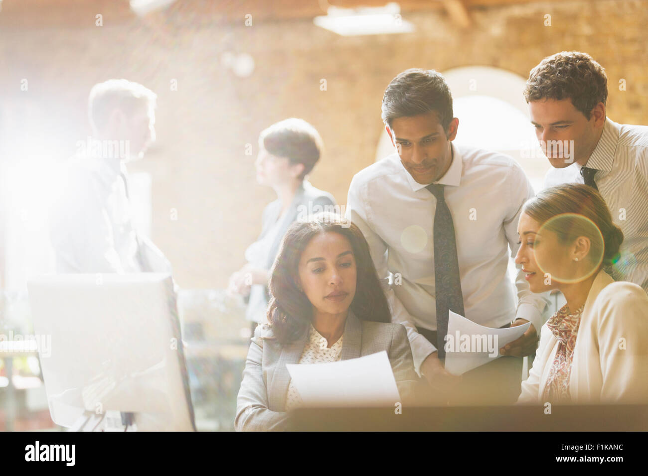 Business people reviewing paperwork in office Stock Photo - Alamy