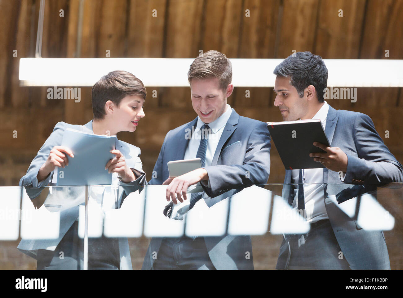 Business people with digital tablet on office balcony Stock Photo