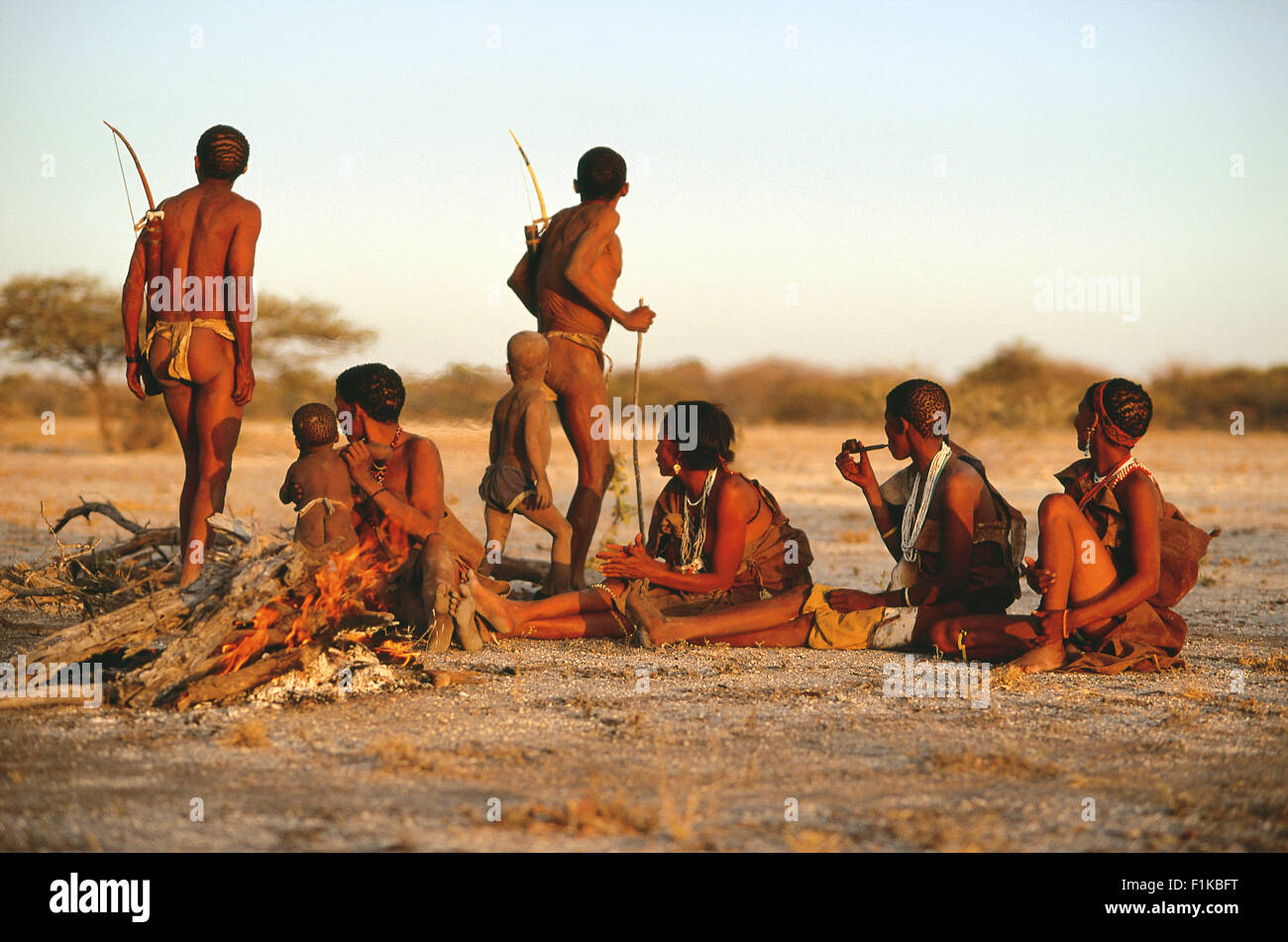 Bushman tribe around fire. Botswana, Africa Stock Photo