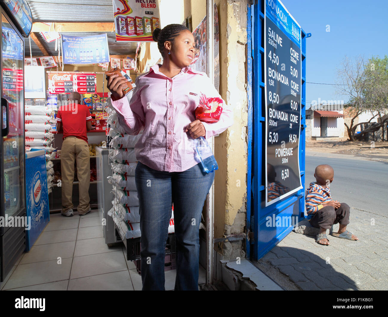 Customer in township spaza shop, Alexandra, Gauteng, South Africa Stock