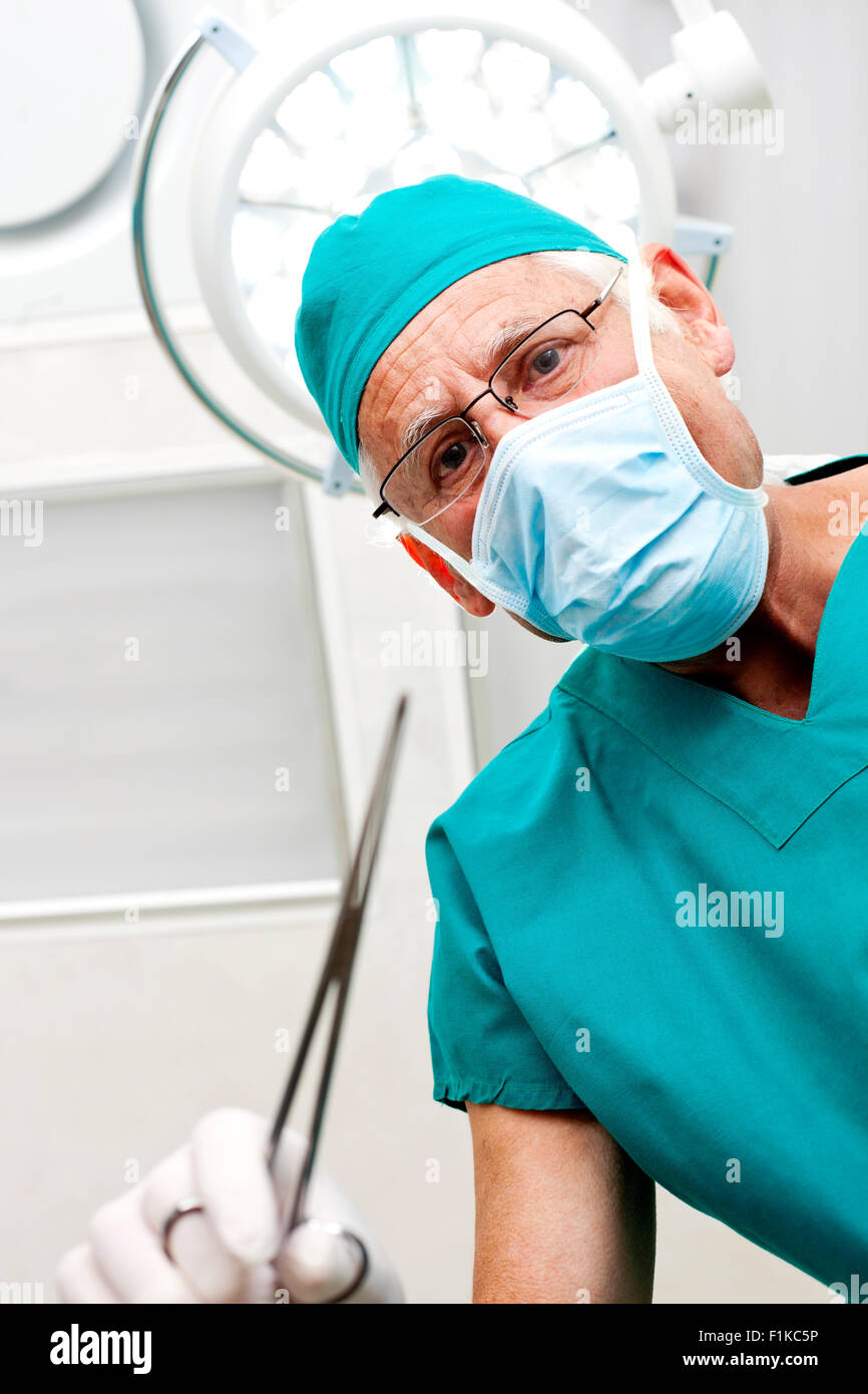 Surgeon holding a medical scissor Stock Photo