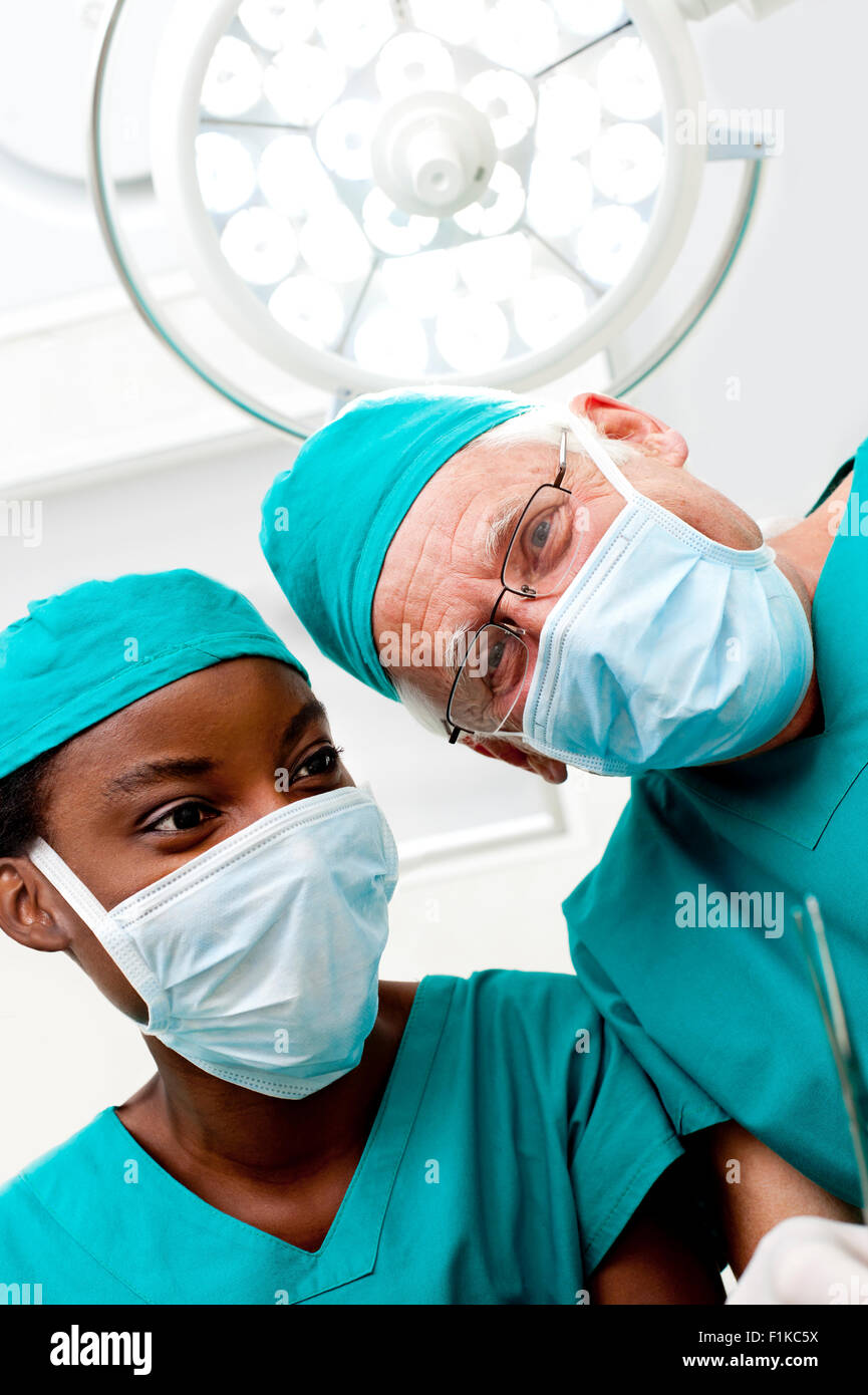 Surgeons looking down Stock Photo - Alamy