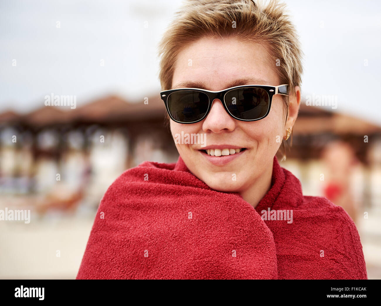 Girl with sunglasses on a sunny beach seaside resort Stock Photo - Alamy