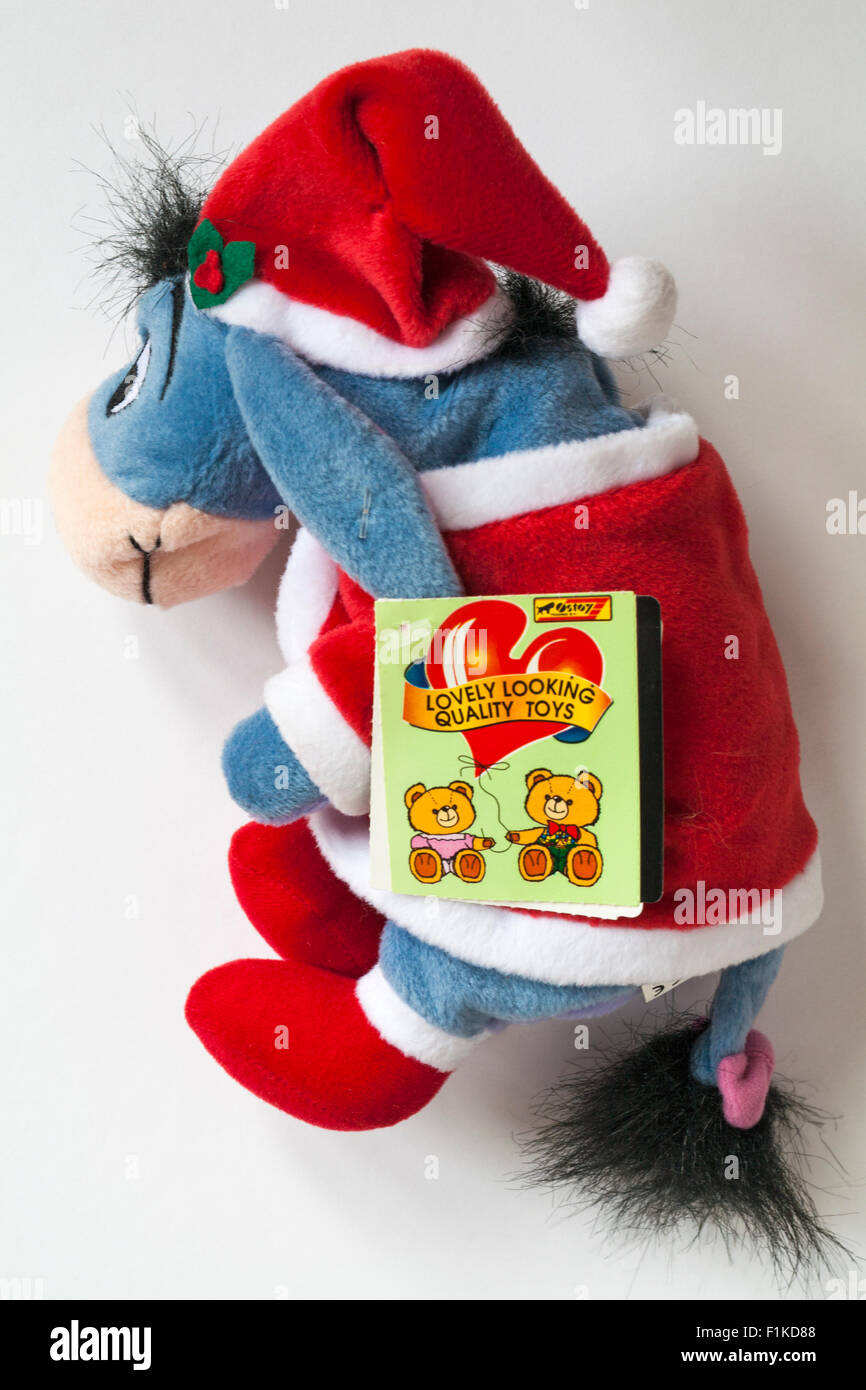 Xmas Santa Eeyore carrying sack of presents soft cuddly toy from Winnie the Pooh isolated on white background Stock Photo