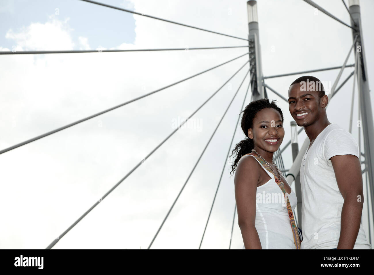 Young African couple standing together on a bridge, Newtown, Johannesburg Stock Photo