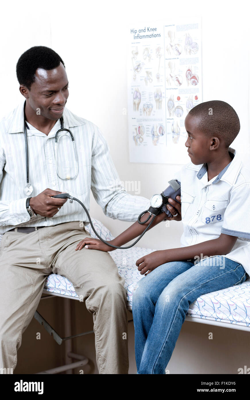Doctor checking African child's blood pressure in a doctor's room Stock ...