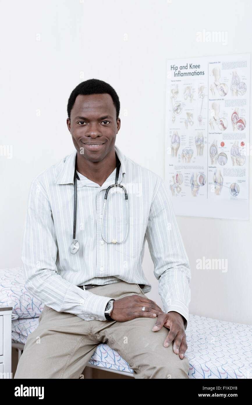 Male African doctor looking at camera, smiling Stock Photo - Alamy