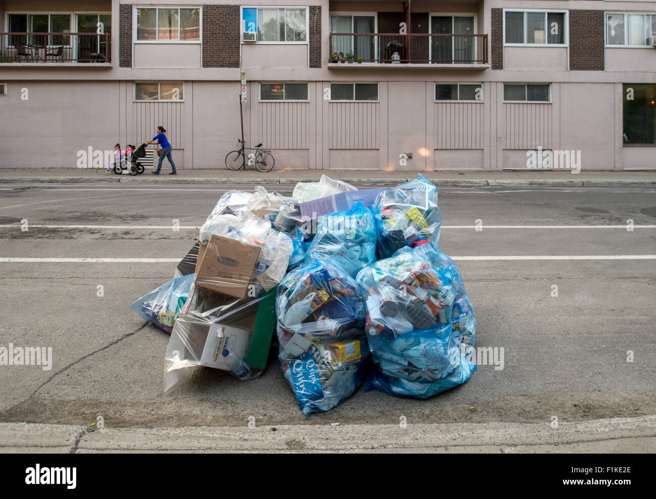 Blue plastic Recycling Rubbish bags put out for recycling on the street
