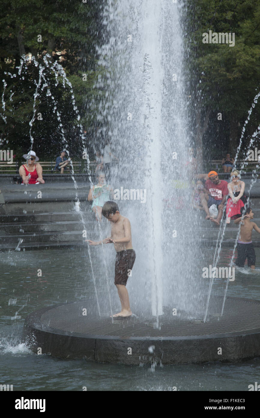 Cooling off in the fountain at Washington Square on a hot summer day in Manhattan; NYC. Stock Photo