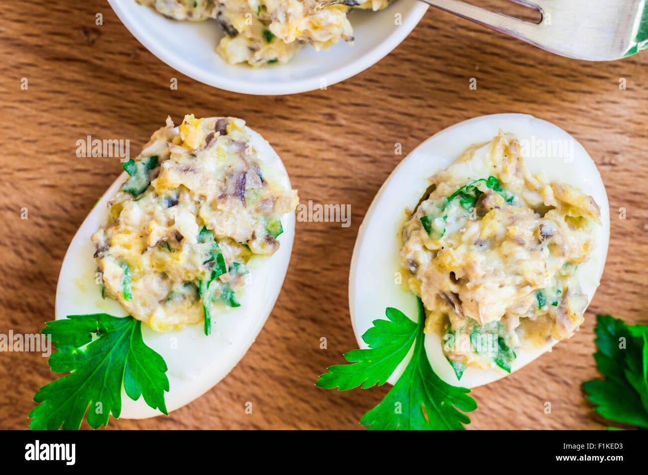 Snack eggs stuffed with egg yolk and fish with mayonnaise top view
