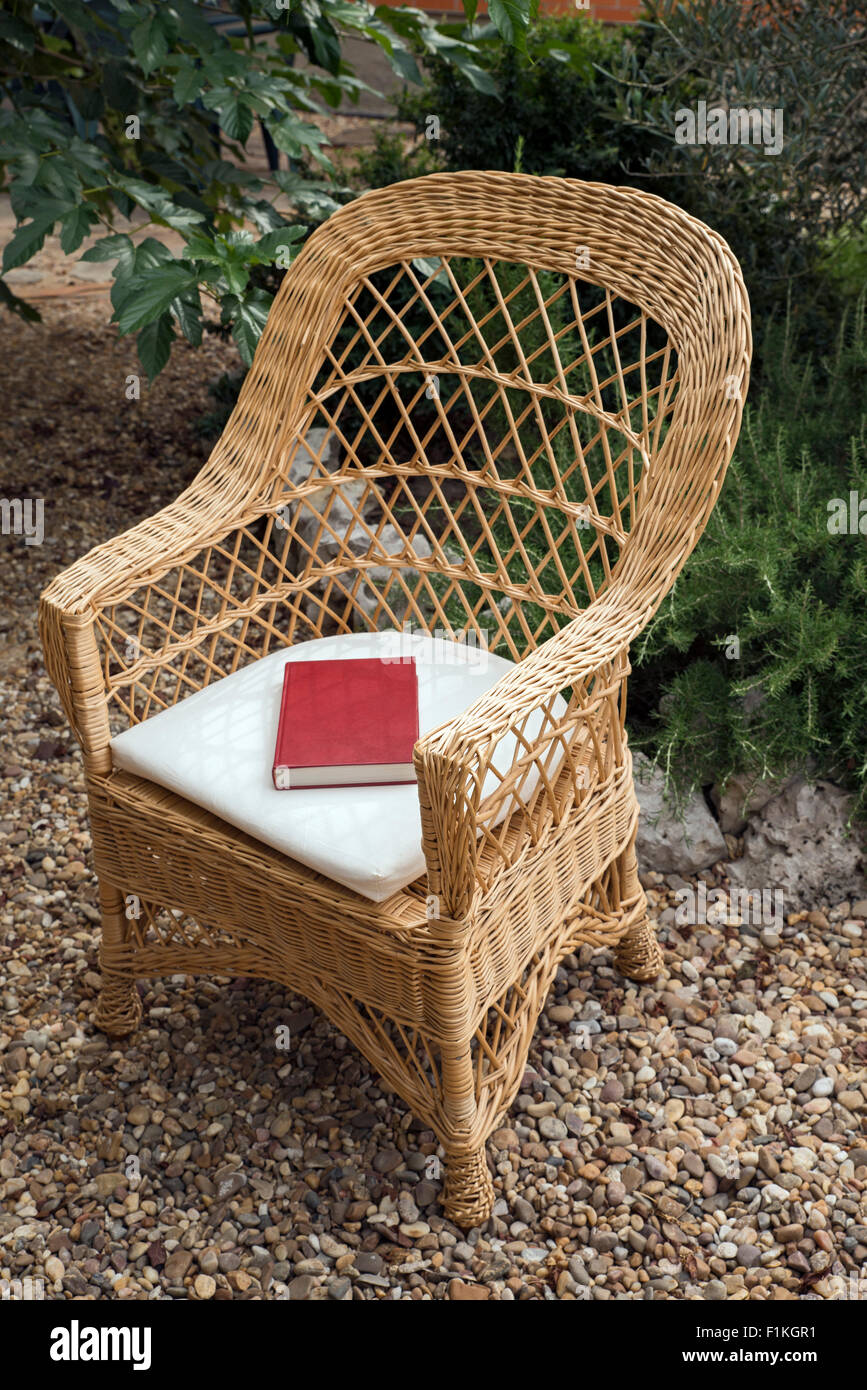 straw chair in a garden with book Stock Photo Alamy
