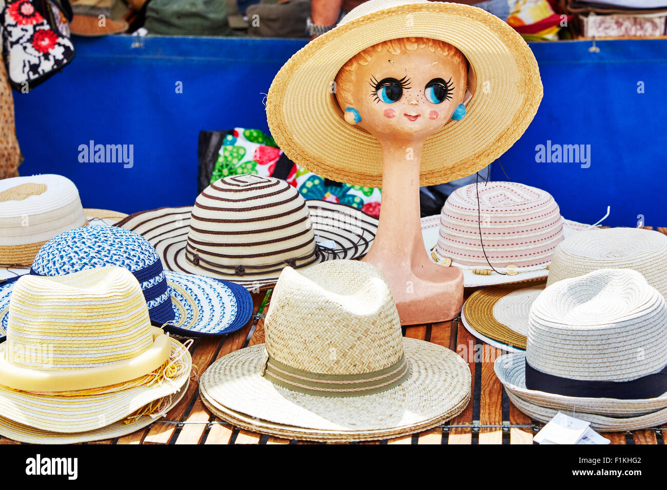 display of hats on a street market stall with a head mannequin in Objat, Correze, Limousin, France. Stock Photo
