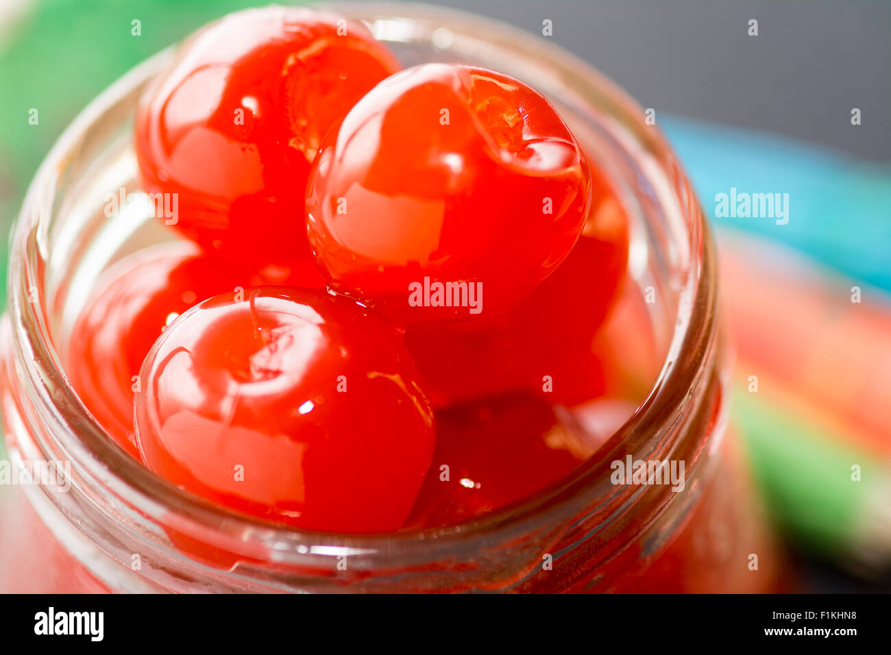 Colourful close up of Maraschino cherries in a jar using a selective