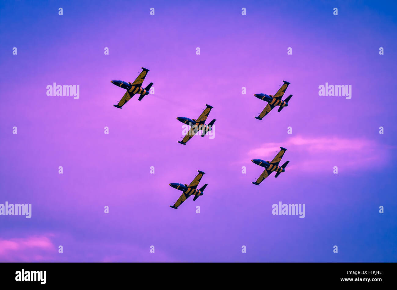 Airplanes on airshow. Aerobatic team performs flight on twilight at air show. Stock Photo