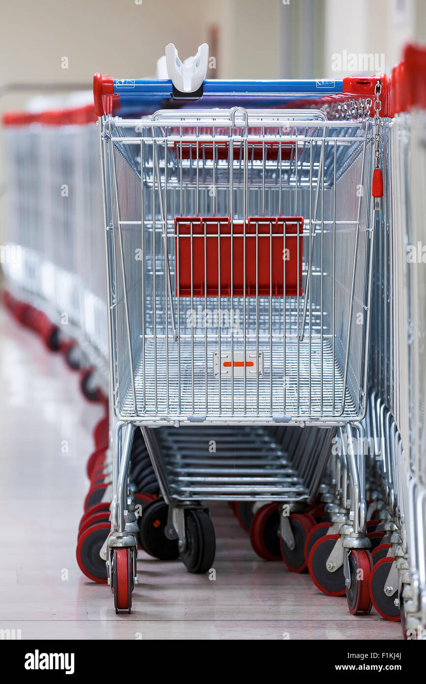 Close-up View of a Row of Stacked Supermarket Trolleys Stock Photo