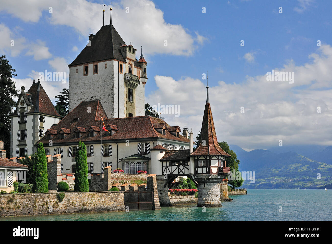 The water castle Schloss Oberhofen along the Tunersee / Lake Thun in the Bernese Alps, Switzerland Stock Photo