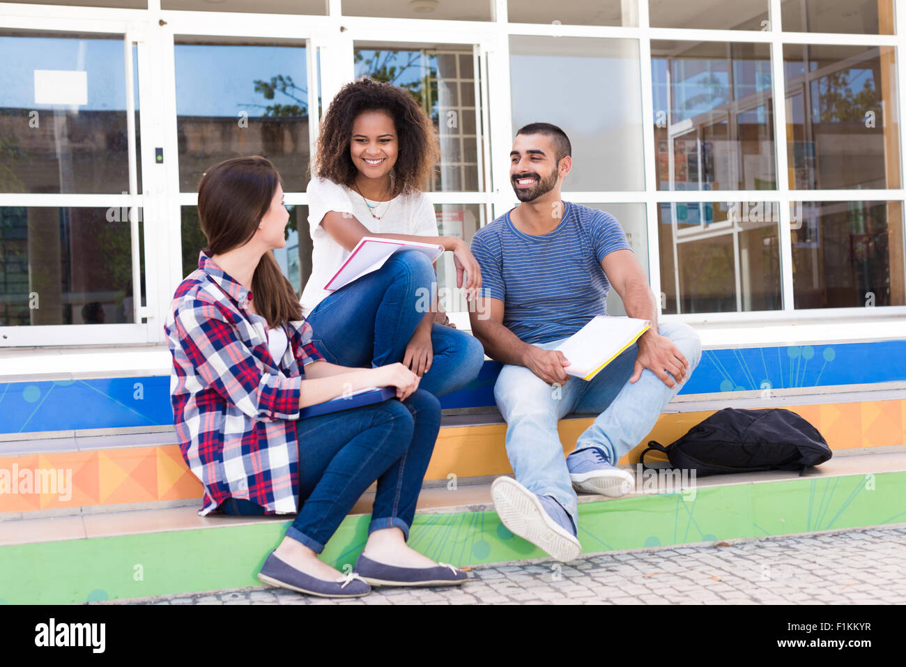 Group of students sitting on school stairs Stock Photo - Alamy