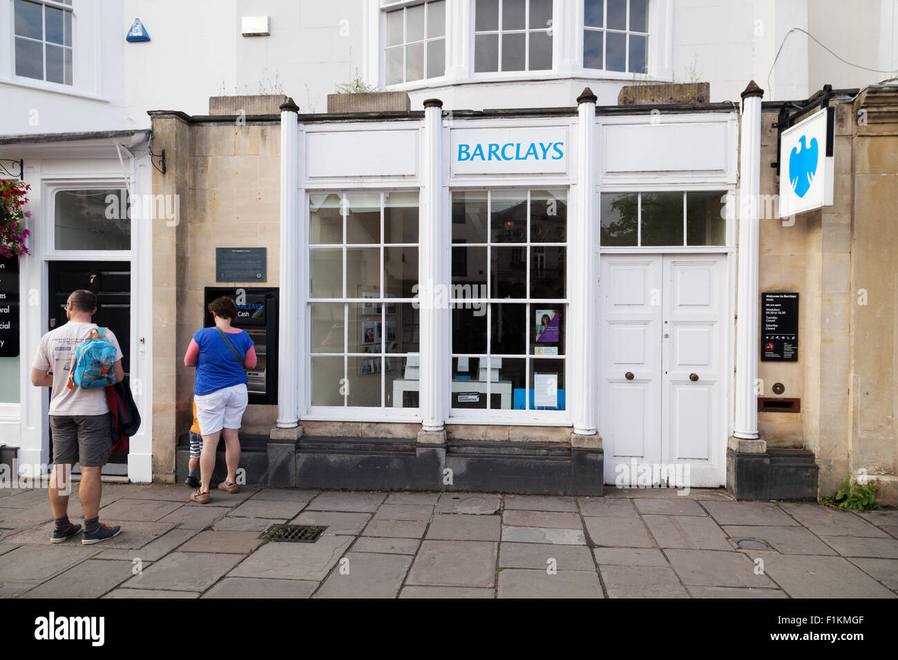 People at the ATM, Barclays Bank, the Market Place, Wells, Somerset UK Stock Photo