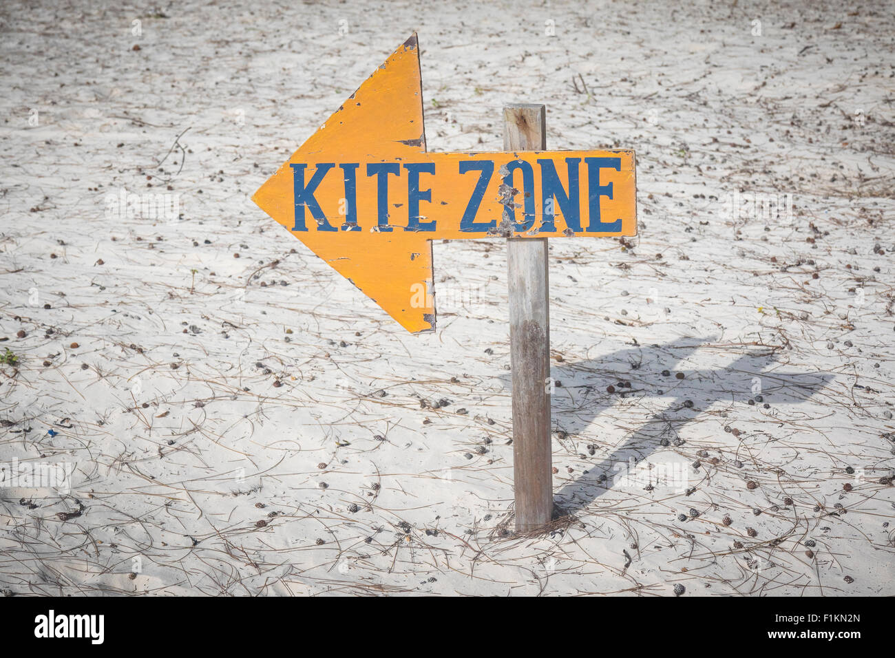 A sign points to the direction of the restricted kite zone area. The sign has a shape of a arrow. Stock Photo