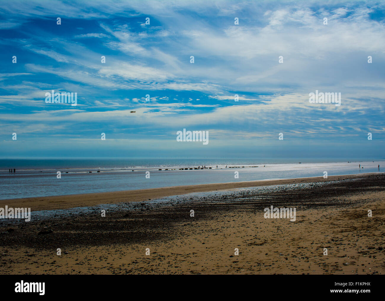 A landscape view of Ulrome beach ,Yorkshire, UK on a summers day with the tide far out. Stock Photo
