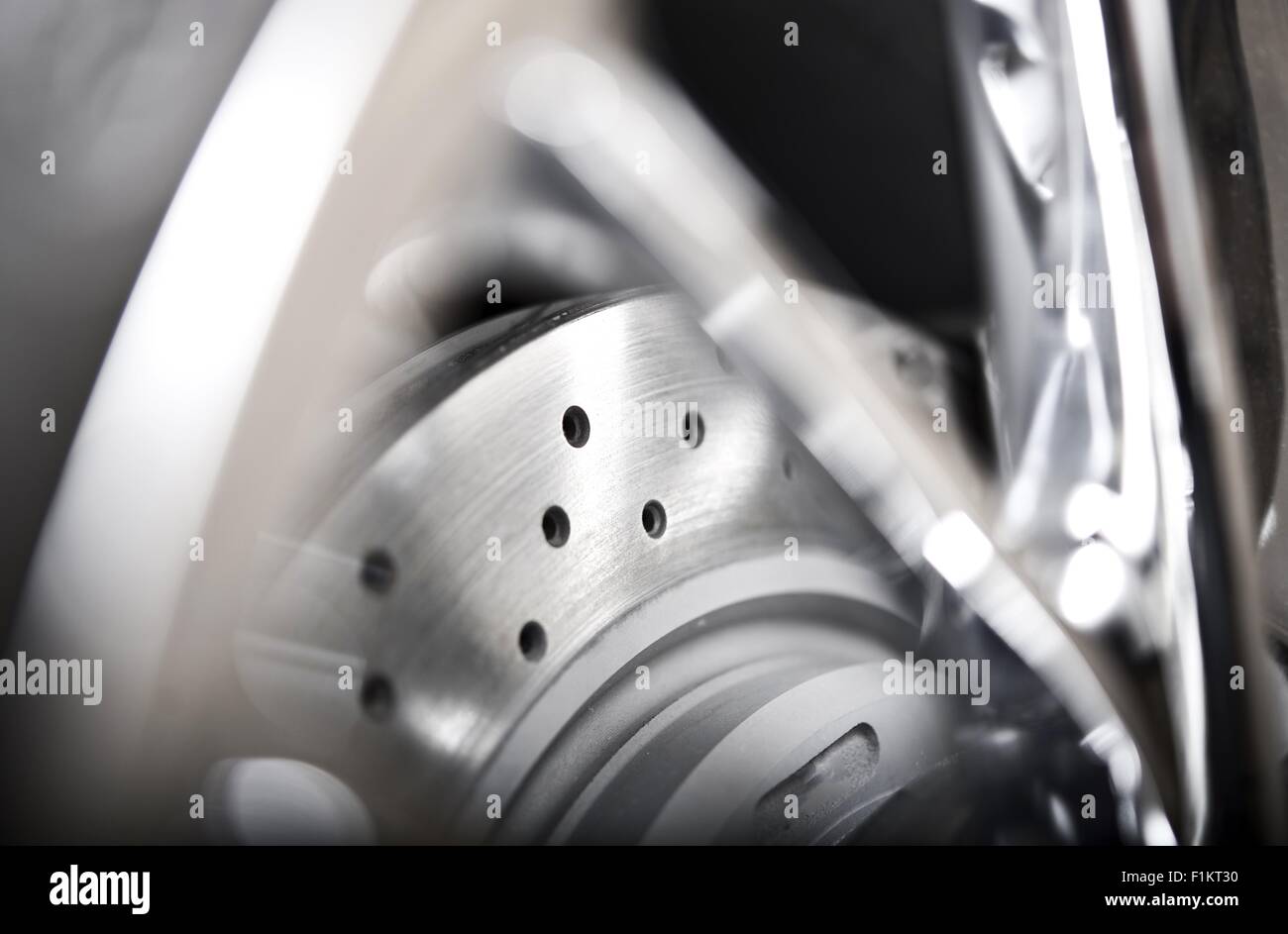 Ventilated Car Brake Disc and Alloy Wheel Closeup. Modern Car Wheel and