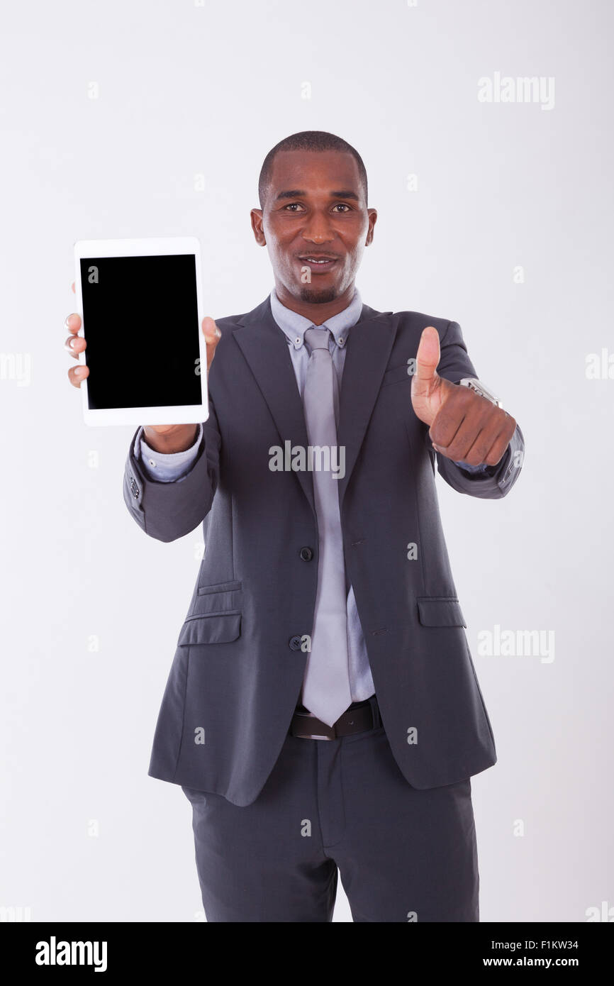 African american business man using a tactile tablet over white ...