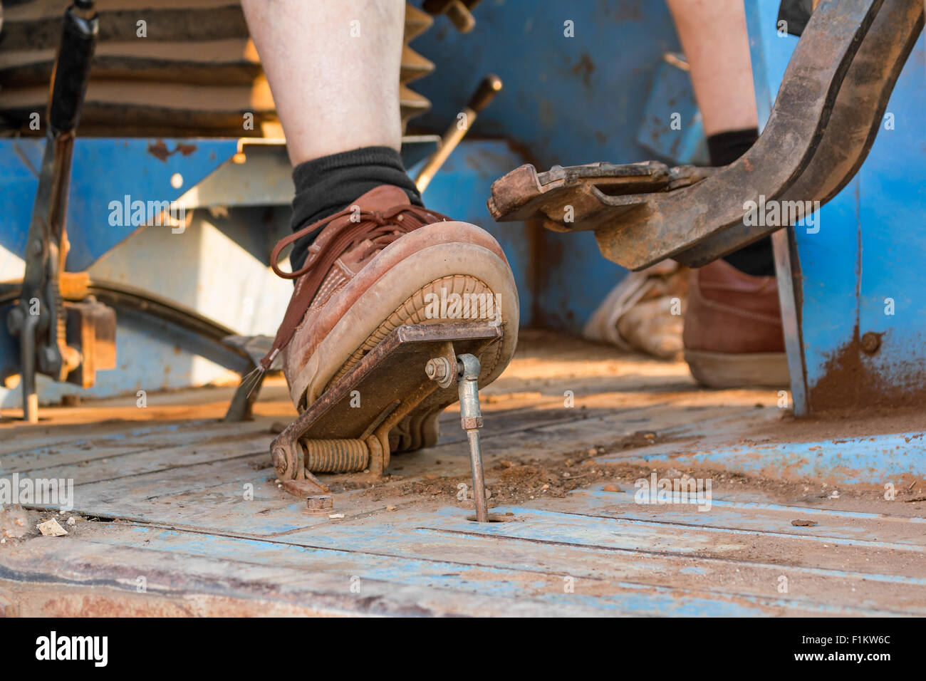 human foot on the pedal of a tractor Stock Photo
