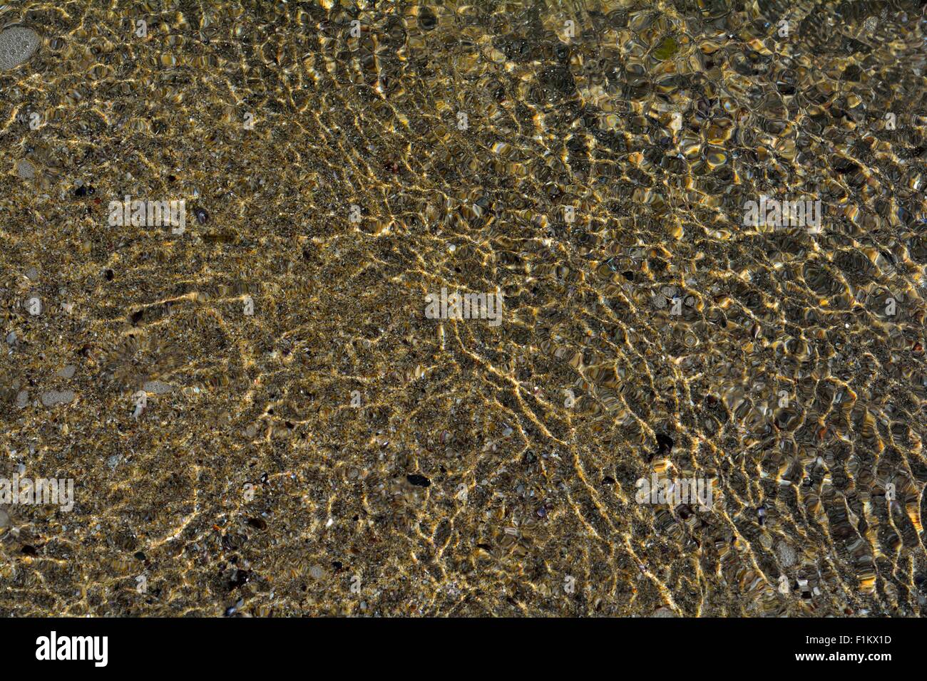Sand seen through seawater Stock Photo