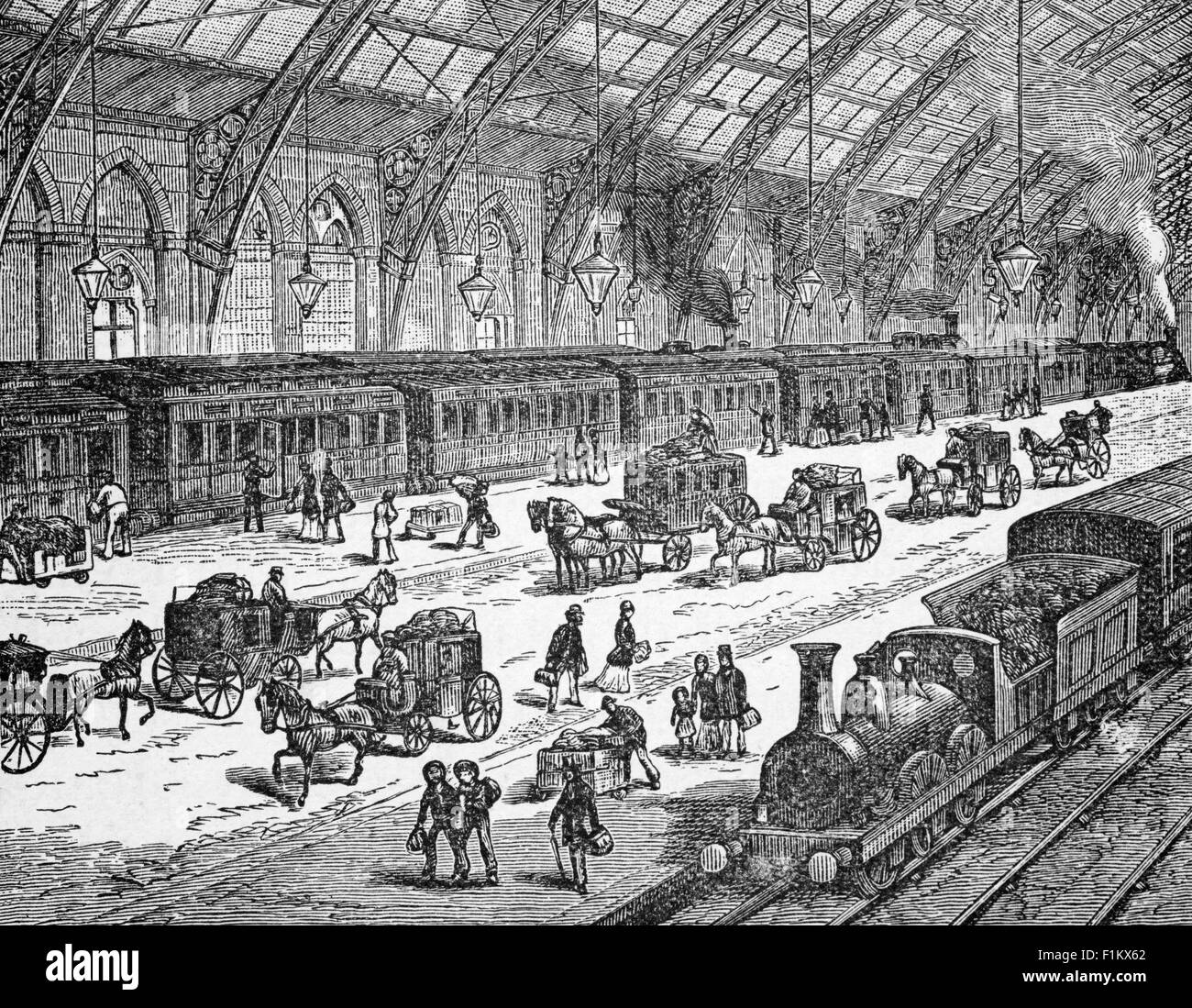 A 19th Century view of an Unknown Railway Station in England with steam locomotives, horses and carriages and hackney carriages. Stock Photo