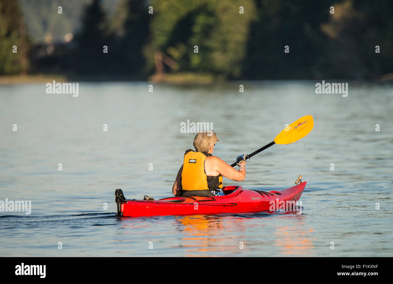 Woman paddling red kayak near Hope Island Marine State Park, Puget