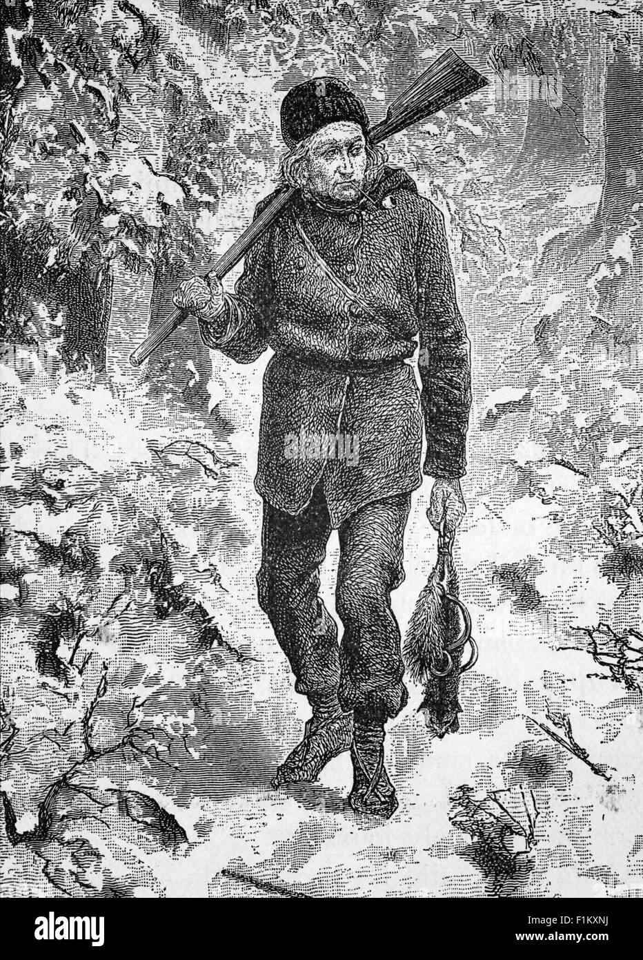 Pipe smoking Canadian Trapper, returning through a snowy forest with his catch -  mink (or similar?) Stock Photo