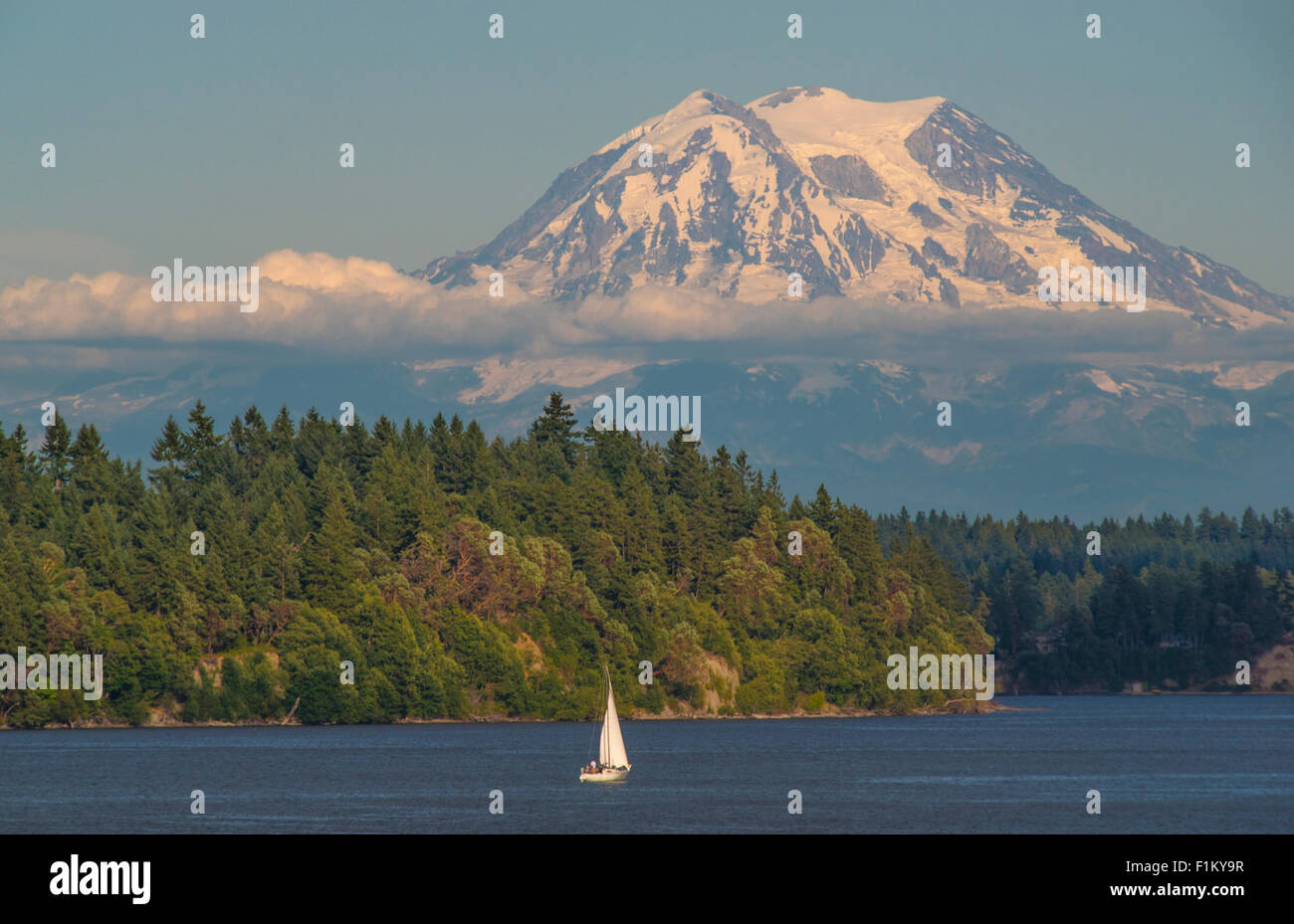 Close up of Mount Rainier and people sailing in sailboat. Puget Sound, Squaxin Island,  Washington State. USA Stock Photo