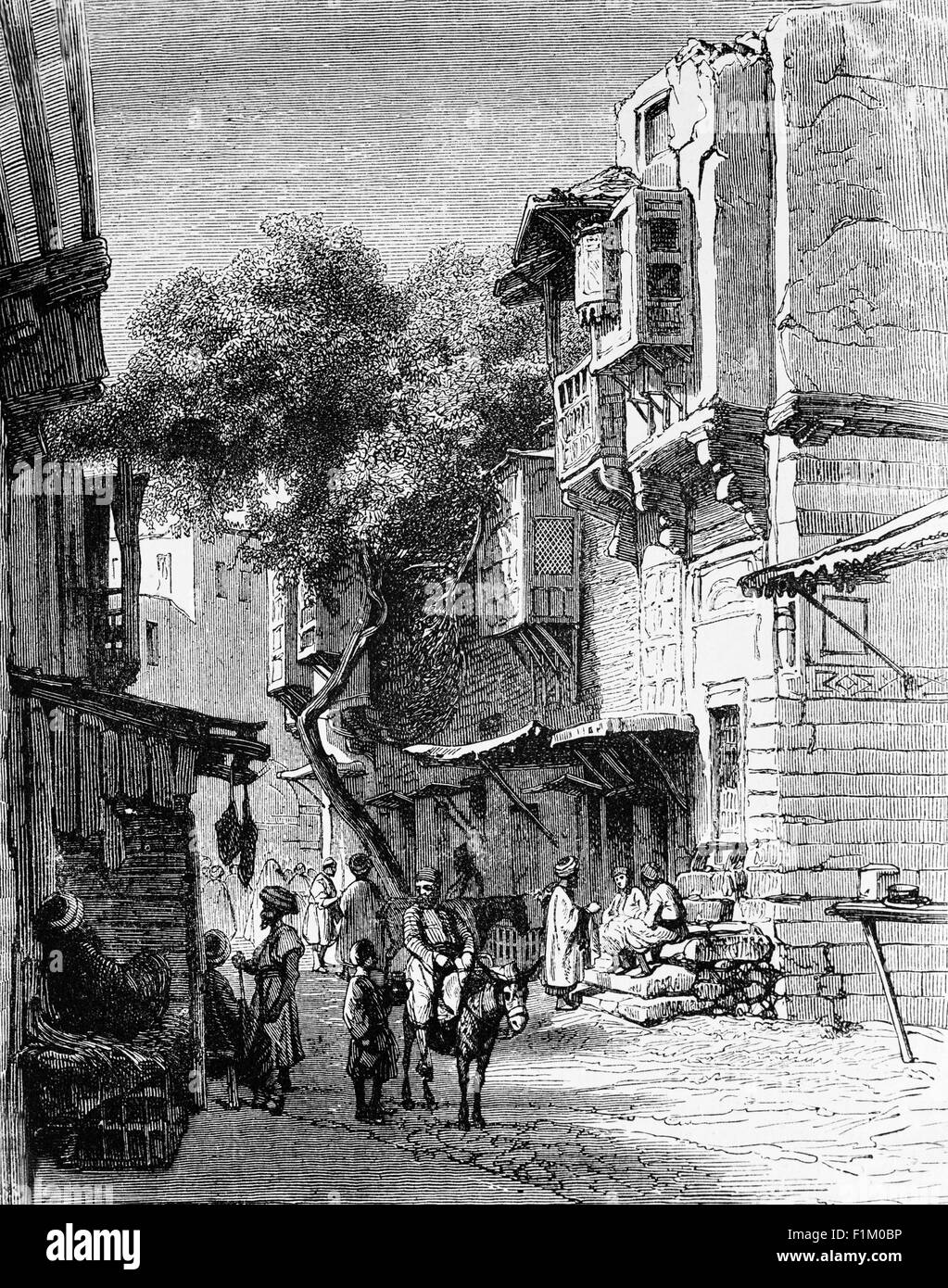 A street scene in 19th Century Cairo, the capital of Egypt. Located near the Nile Delta, Cairo was founded in 969 AD by the Fatimid dynasty, but the land composing the present-day city was the site of ancient national capitals whose remnants remain visible in parts of Old Cairo. Cairo has long been a centre of the region's political and cultural life, and is titled 'the city of a thousand minarets' for its preponderance of Islamic architecture. Stock Photo